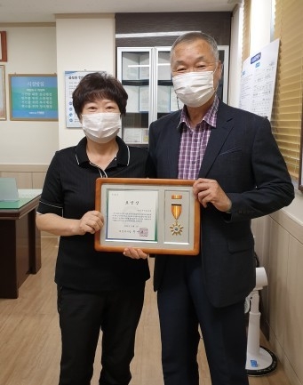 이순희 가능동새마을부녀회 회장(왼쪽)이 제25회 노인의 날을 맞아 유공표창을 수상후 홍승의 가능동장(오른쪽)과 기념촬영하고 있다.(사진설명)